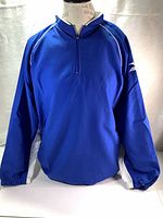 Front view of royal blue Mizuno wind jacket with white accents, half zipper and elastic cuffs.