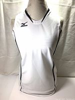 Front view of white sleeveless athletic shirt on dress form showing Mizuno logo on chest and black piping on side seams.
