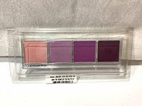 Photo of the four eyeshadow pans inside the refill case showing shades of pink and purple.