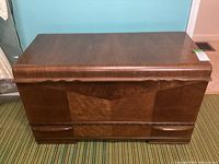 Front view of the red seal cedar chest showing wood grain and pull-out drawer.