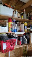 Wide view of shelves with various chemical bottles and sprays for garden, automotive, and tool use.