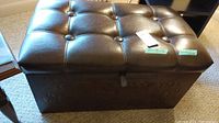 Photo showing top of the vinyl ottoman with button tufting and storage lid closed