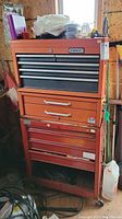 Front view of Stanley metal tool chest showing drawers and top shelf with containers