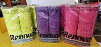 Front view of 5 Renova branded toilet paper packages in lime green, hot pink, and purple colors, each package containing 6 rolls.