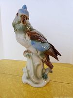 Front side view of large ceramic bird perfume lamp with blue and brown glaze details.