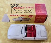 Dinky Toys #113 M.G.B. Sports Car with box showing front and top view, white with red seats.