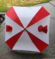 Top view of large umbrella with white and red panels and two pockets visible on opposite red panels.