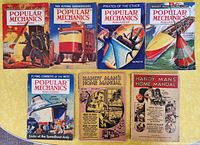 Full lot overview showing 5 vintage Popular Mechanics magazines and 2 Handy Man's Home Manuals, all with colorful illustrated covers.