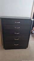 Frontal view of chest showing five drawers and silver handles