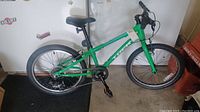 Full side view of green Trek Superfly BMX bicycle with 20-inch wheels.