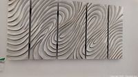 Five-panel relief wall art from a front view, showing overall design and layout on the wall.