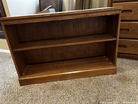 Bookshelf shown at an angle to display depth and shelves.