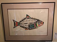 Full view of framed print showing fish design and frame.