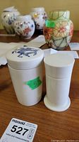 Both porcelain boxes side by side on table