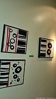 Three framed quilt art pieces displayed on wall