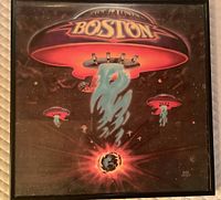 Framed Boston LP cover showing spaceship artwork, encased behind glass in metal frame with hanger