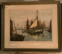 Framed early 1920s woodcut print of sailing ship in harbor, artist signed lower right corner.