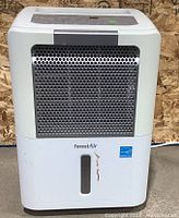White ForestAir dehumidifier with black/grey vent and water level indicator, showing some wear on front panel.