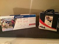 Photo showing Sportscraft ladder ball game box with product image and FILA tote bag for toss game.