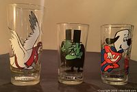 Front view of three Pepsi collector glasses showing characters Orville, Snidely Whiplash, and Underdog
