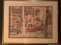 Framed print showing Toronto streetcar traveling west on Queen Street with detailed urban surroundings in muted color tones.