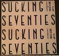 Front cover of The Rolling Stones - Sucking In The Seventies vinyl record with bold black text on white background.