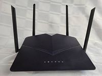 D-Link DIR-2640 Wireless Router front with visible status LEDs and four antennas extending from each corner.