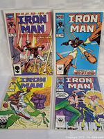 Four Iron Man comic books laid out with clear visibility of covers, showing issues 206, 207, 208, and 212.