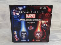 Box front showing Marvel Cinematic Universe themed Trivial Pursuit game with Marvel characters and themed labels.