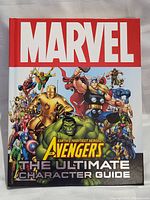 Front cover of the Marvel Avengers The Ultimate Character Guide hardcover book showing multiple Avengers characters and title text.