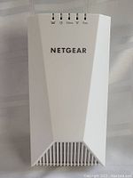 Front view showing NETGEAR logo and LED indicators for power, 2.4GHz, 5GHz WiFi bands, and WiFi status.