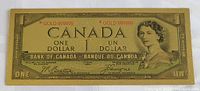 Full view of the novelty Canadian one dollar bill showing the front design with portrait and gold markings.