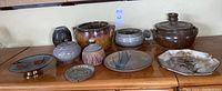 Full view of all pottery pieces and brass plate together showing size and variety.