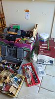 Wide view showing entire lot with toolbox, hardware in various containers and unopened Kenmore disposer box