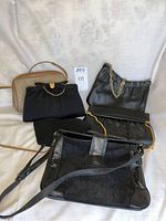 Lot photo showing 6 vintage purses in black and beige, various styles and materials