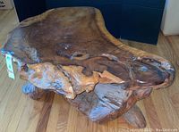 Top and side view of burl wood slab surface showing grain, knots and natural voids