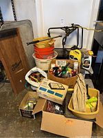 Wide view of assorted car care and bicycle items including buckets, creeper, bottles, and bike rack.