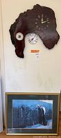 Full view of burlwood clock with thermometer and framed Vietnam War Memorial print beneath