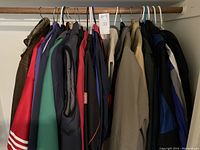 Full rack showing 11 of the 24 assorted coats, vests and jackets