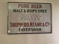 Full view of framed vintage beer sign showing main text and condition.