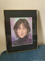 Full front view of the framed print showing John Lennon's portrait with black mat and metal frame.