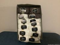 Full set of 13 balls of mohair yarn in box, 10 cream and 3 brown, boxed.