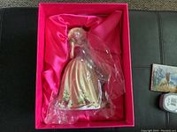Royal Albert Old Country Rose 2010 figurine in original pink satin-lined box, wrapped in protective plastic.