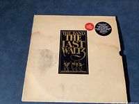 Front album cover with water stains, damage, and title sticker