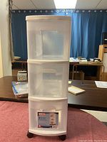 Full view of the Sterilite 3 drawer plastic storage cart with translucent white drawers and top, showing three drawers and wheels at bottom.