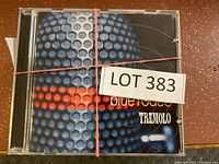 Photo of front CD showing Blue Rodeo album titled Tremolo, with a blue and red circular patterned background and 