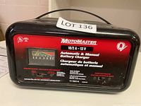 Front view of MotoMaster 12V battery charger with label showing operation instructions and charge rate meter.