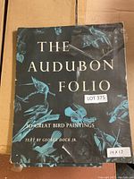 Cover of The Audubon Folio featuring bird illustrations and title, with a lot sticker and size label (14x17).