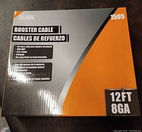 Box of iLINK brand booster cables showing product information including 12ft length and 8 gauge wire thickness.