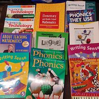 Photo showing multiple educational books on science, writing, phonics, and mathematics focused on homeschooling and learning.
